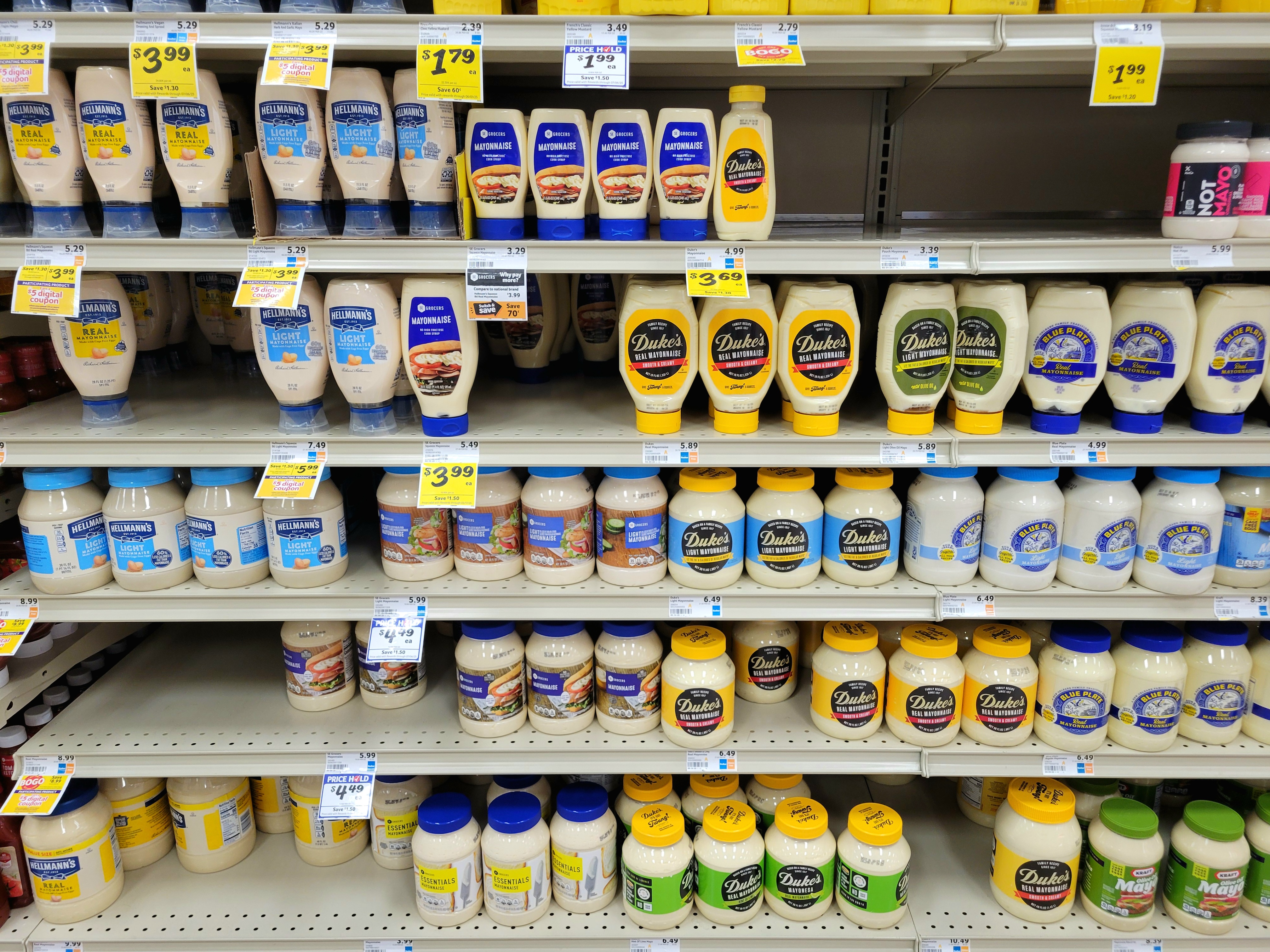 Shelves of mayonnaise at a grocery store.